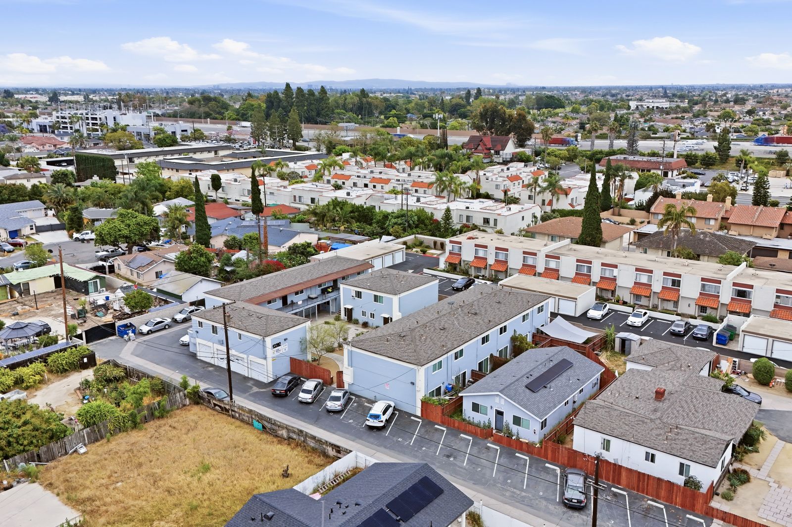 Aerial view of the property within the neighborhood