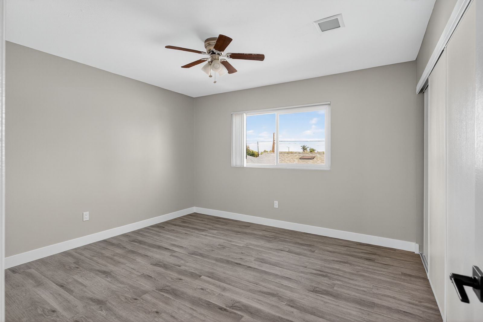 Bedroom with ceiling fan and neighborhood view