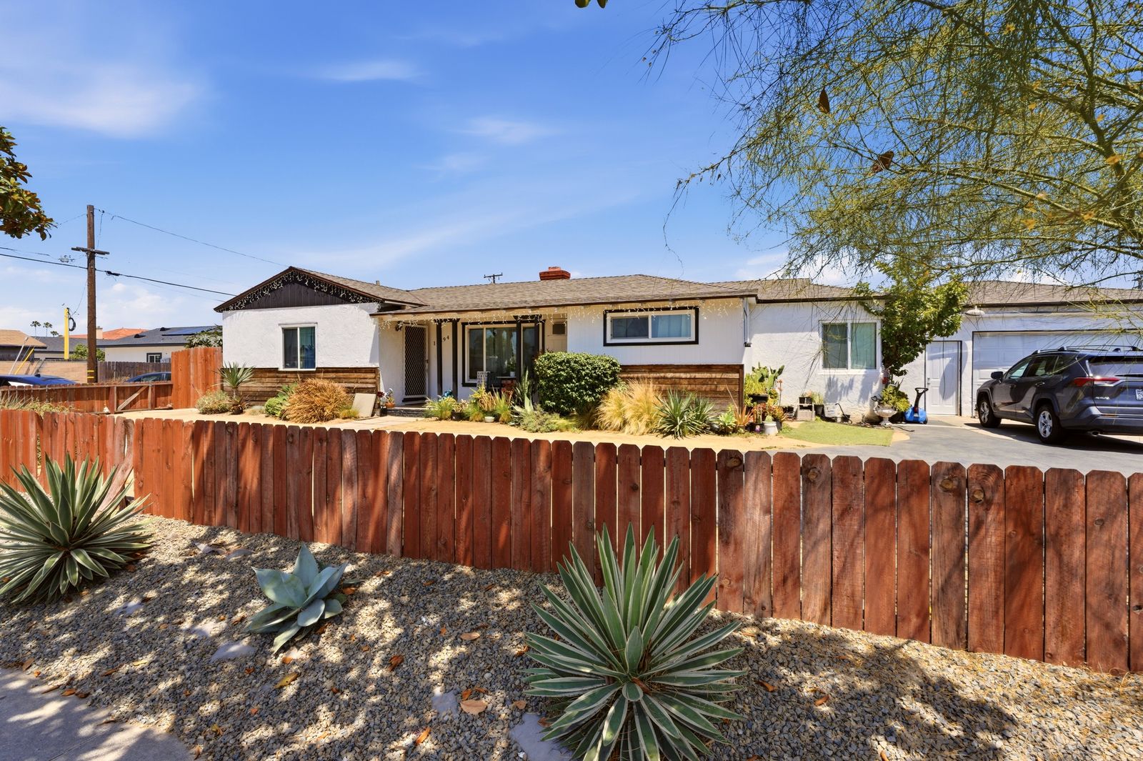 Front exterior of the single-family home with desert landscaping