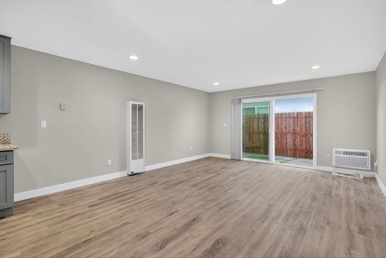 Living room with slider to the fenced patio
